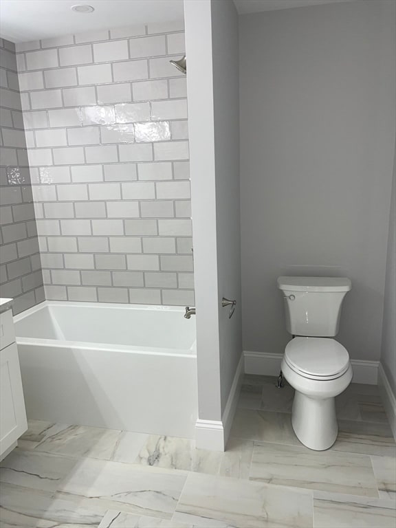 full bathroom featuring vanity, toilet, and tiled shower / bath