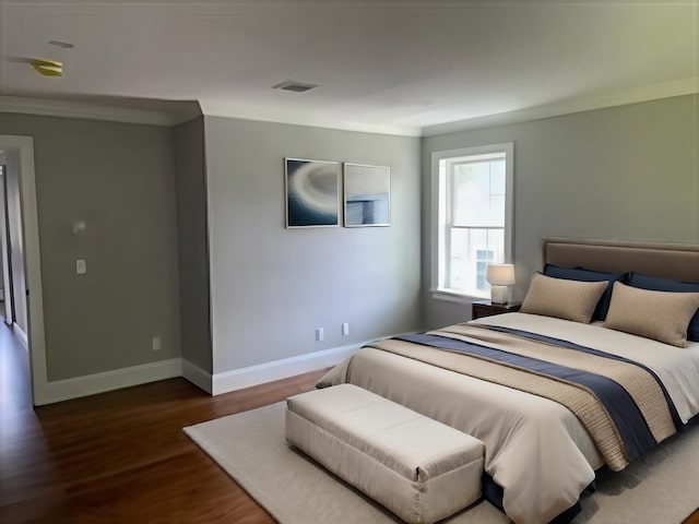 bedroom featuring dark hardwood / wood-style floors and ornamental molding