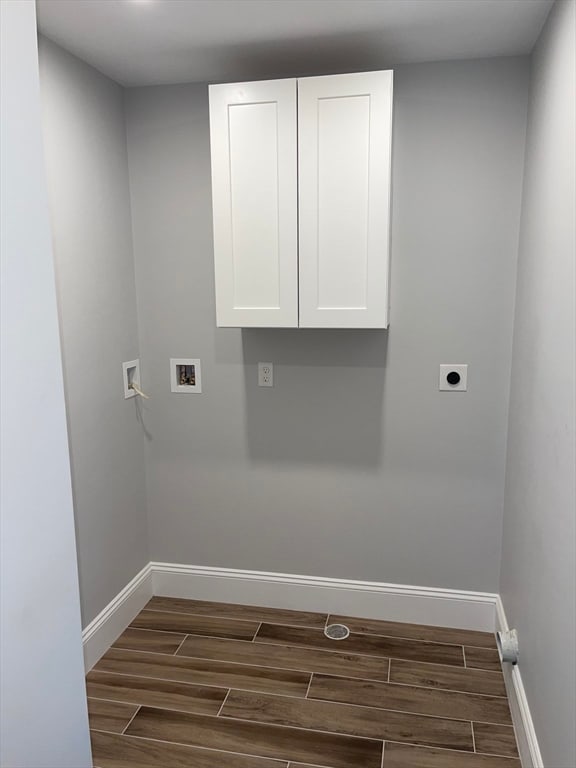 washroom featuring hookup for an electric dryer, dark hardwood / wood-style flooring, cabinets, and hookup for a washing machine