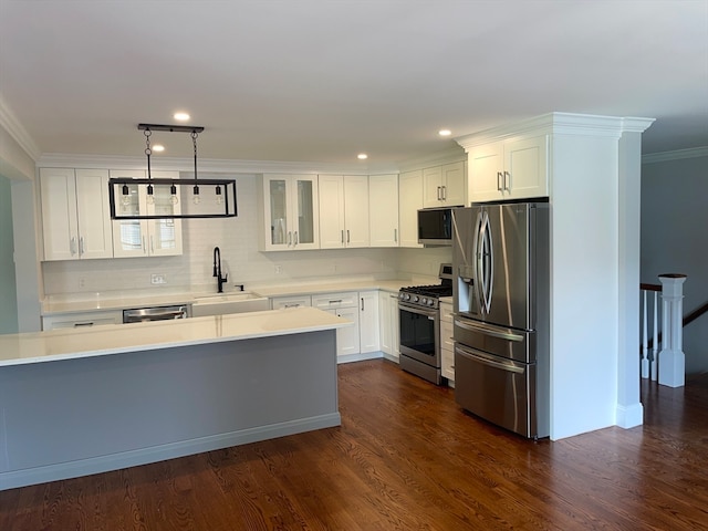 kitchen featuring white cabinets, sink, stainless steel appliances, and dark wood-type flooring