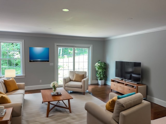 living room with a healthy amount of sunlight, crown molding, and light hardwood / wood-style flooring