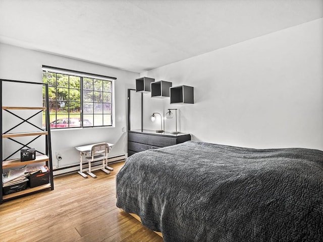 382 Great Rd Unit B103, Acton, MA 01720 - bedroom with a baseboard radiator and light wood-type flooring