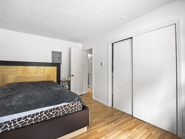 382 Great Rd Unit B103, Acton, MA 01720 - bedroom with light wood-type flooring, electric panel, and a closet