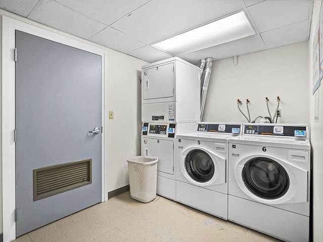 382 Great Rd Unit B103, Acton, MA 01720 - communal laundry room featuring stacked washing machine and dryer, washing machine and clothes dryer, and baseboards