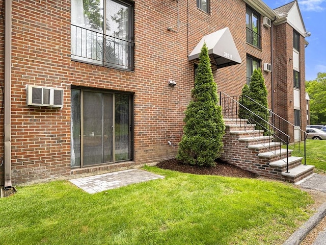 382 Great Rd Unit B103, Acton, MA 01720 - back of property featuring a lawn and brick siding
