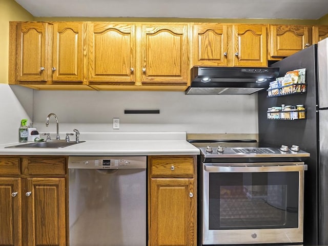 382 Great Rd Unit B103, Acton, MA 01720 - kitchen featuring stainless steel appliances, under cabinet range hood, a sink, light countertops, and brown cabinets