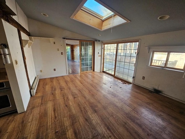 unfurnished living room featuring a baseboard heating unit, lofted ceiling with skylight, and wood finished floors