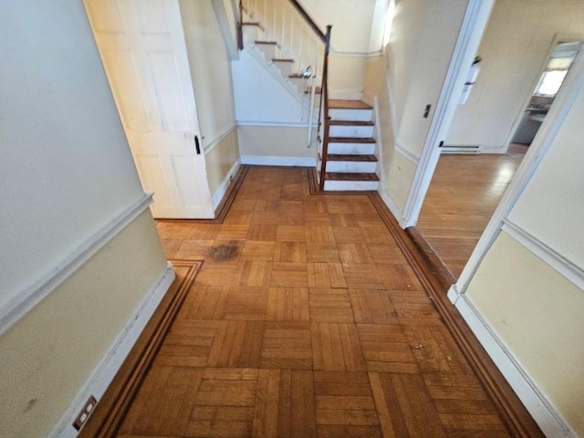 corridor with baseboards and stairs