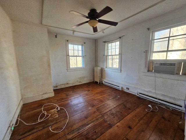 unfurnished room featuring ceiling fan, hardwood / wood-style floors, radiator heating unit, and a baseboard radiator