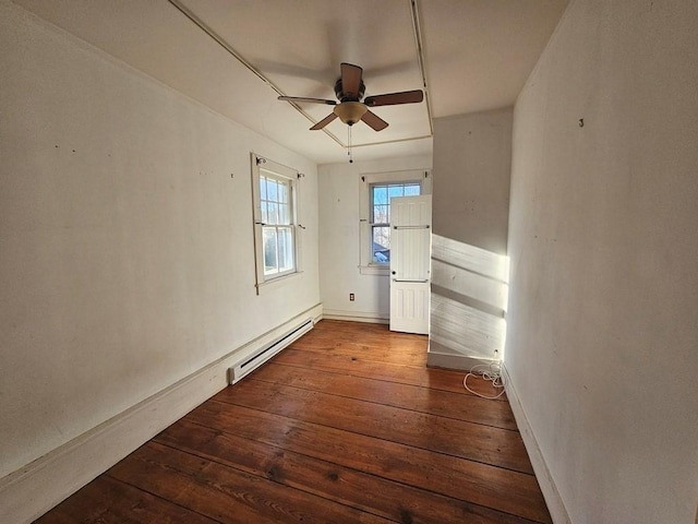 unfurnished room with ceiling fan, a baseboard radiator, baseboards, and wood-type flooring