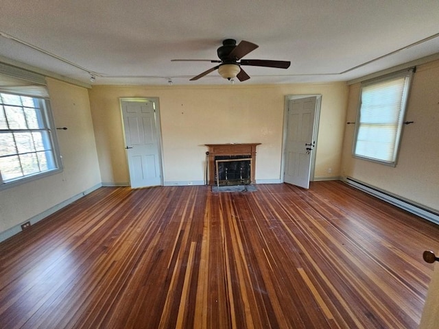 unfurnished living room featuring wood-type flooring, a fireplace, baseboards, and ceiling fan