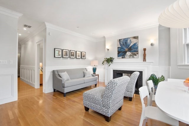 living room featuring crown molding and hardwood / wood-style flooring