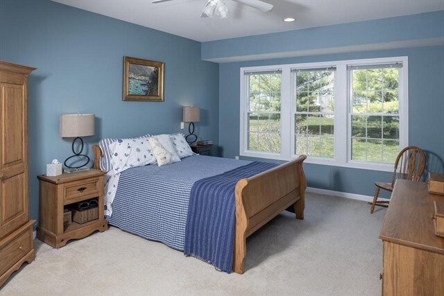 bedroom featuring a ceiling fan, baseboards, and light colored carpet