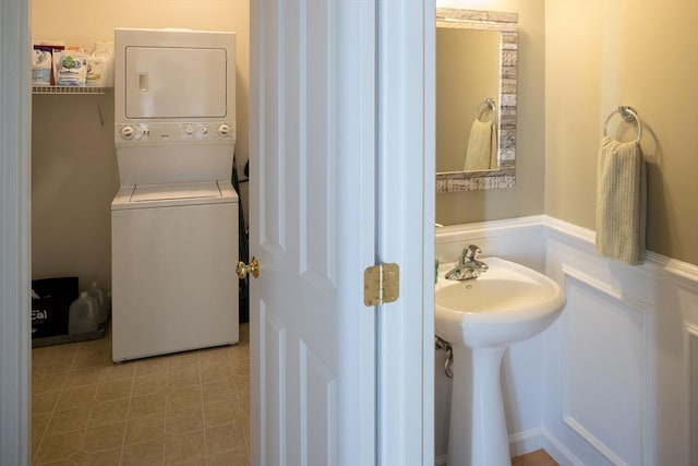 bathroom featuring stacked washer and dryer