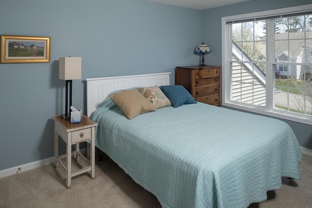bedroom with carpet and baseboards