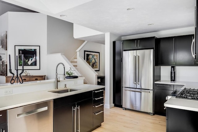 23 Matt Hoxie Trl Unit 23, Plymouth, MA 02360 - kitchen with stainless steel appliances, a sink, dark cabinets, light wood-style floors, and recessed lighting