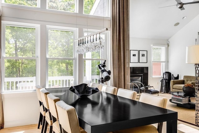 23 Matt Hoxie Trl Unit 23, Plymouth, MA 02360 - dining room featuring a ceiling fan, a tiled fireplace, vaulted ceiling, and light wood-style floors
