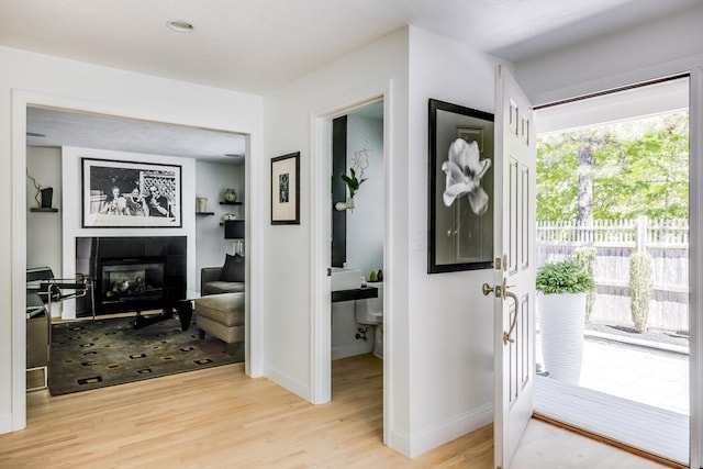 23 Matt Hoxie Trl Unit 23, Plymouth, MA 02360 - entrance foyer featuring light wood-style floors, a fireplace, and baseboards