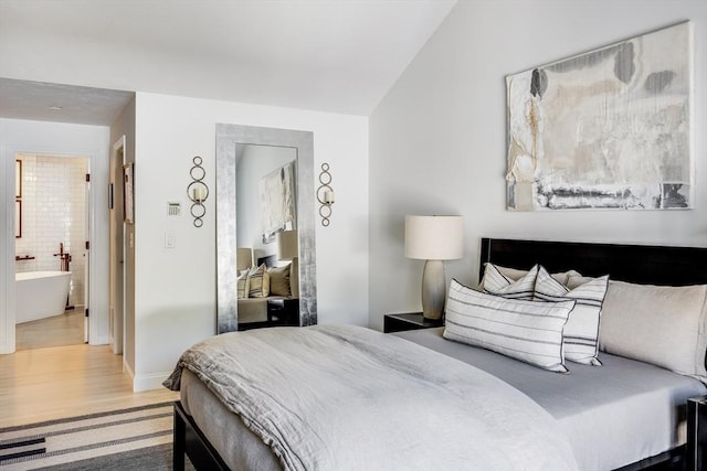 23 Matt Hoxie Trl Unit 23, Plymouth, MA 02360 - bedroom featuring wood finished floors, lofted ceiling, ensuite bath, and baseboards