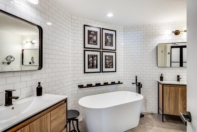 23 Matt Hoxie Trl Unit 23, Plymouth, MA 02360 - full bath with tile walls, two vanities, a freestanding bath, and decorative backsplash