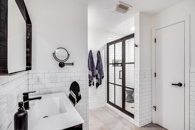 23 Matt Hoxie Trl Unit 23, Plymouth, MA 02360 - full bath with tile walls, a shower stall, vanity, and wainscoting