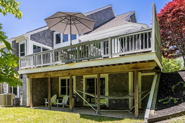 23 Matt Hoxie Trl Unit 23, Plymouth, MA 02360 - back of property with a wooden deck, central AC unit, and a shingled roof