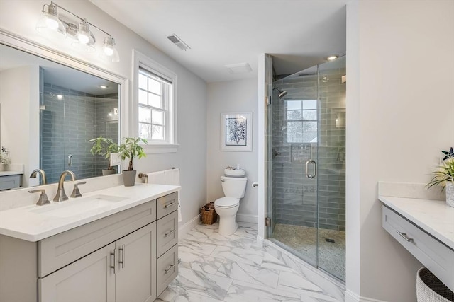 bathroom with vanity, toilet, and a shower with shower door