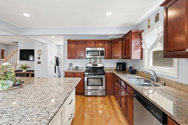 39 Doyle Ave, Dracut, MA 01826 - kitchen with appliances with stainless steel finishes, recessed lighting, light wood-type flooring, and light stone counters