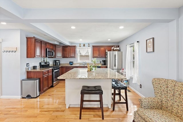 39 Doyle Ave, Dracut, MA 01826 - kitchen featuring appliances with stainless steel finishes, a kitchen breakfast bar, light wood-style flooring, a kitchen island, and recessed lighting
