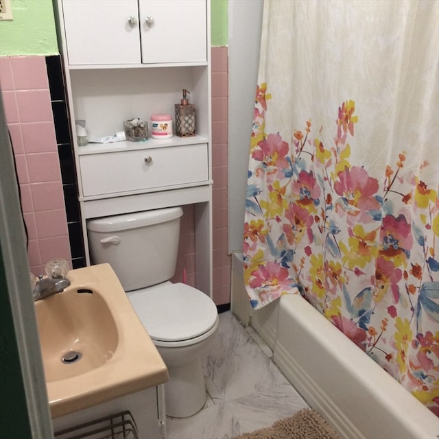 full bathroom with shower / bath combo, toilet, tile flooring, and sink