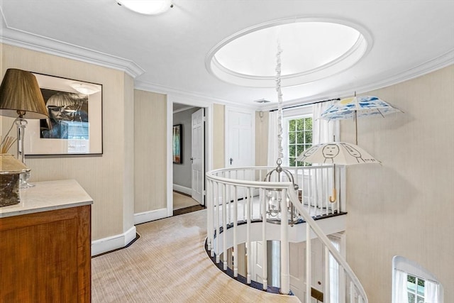 hall featuring light carpet, ornamental molding, an upstairs landing, and baseboards