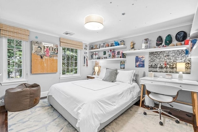 bedroom featuring ornamental molding, visible vents, and baseboards