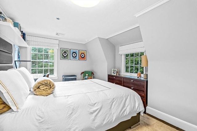 bedroom with baseboards, visible vents, ornamental molding, and wood finished floors