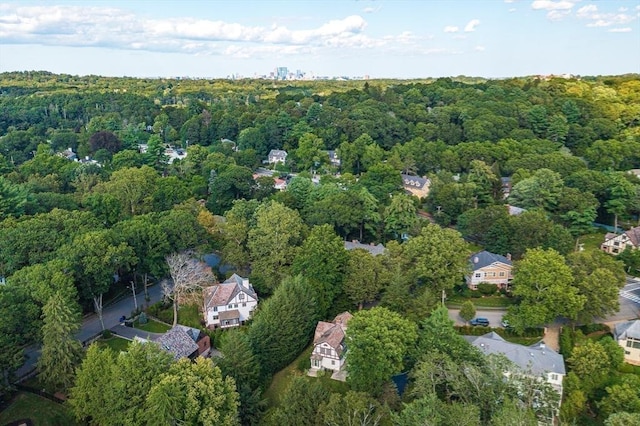 bird's eye view with a wooded view