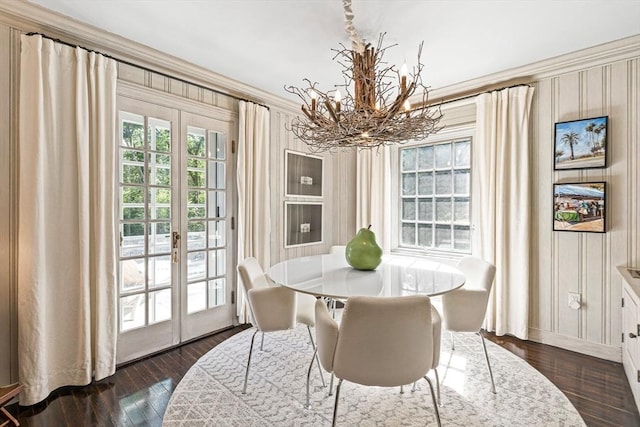 dining space featuring dark wood-style floors, plenty of natural light, baseboards, and french doors