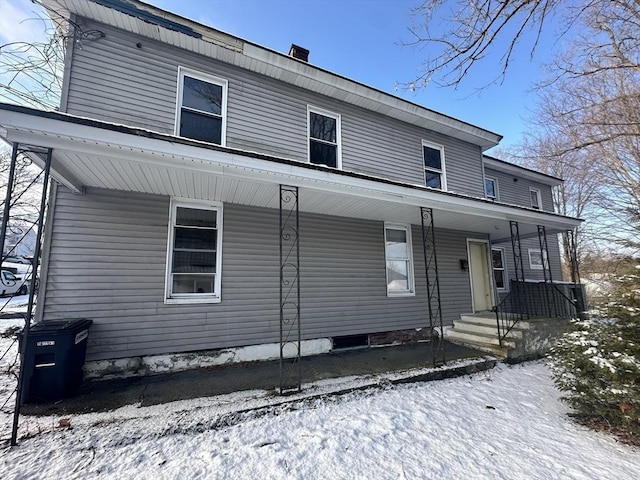 view of front of property featuring covered porch and a chimney