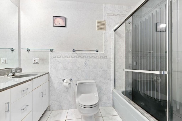 24 Crestview Dr Unit 24, Malden, MA 02148 - full bathroom featuring vanity, tile walls, and bath / shower combo with glass door