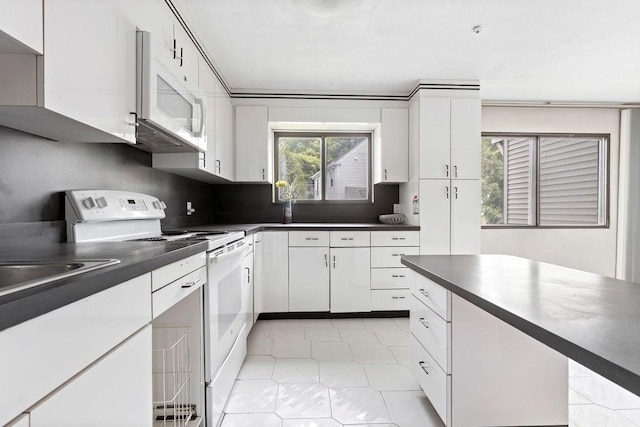 24 Crestview Dr Unit 24, Malden, MA 02148 - kitchen with white appliances, dark countertops, white cabinetry, and light tile patterned flooring
