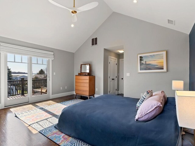 bedroom with high vaulted ceiling, access to exterior, wood finished floors, and visible vents