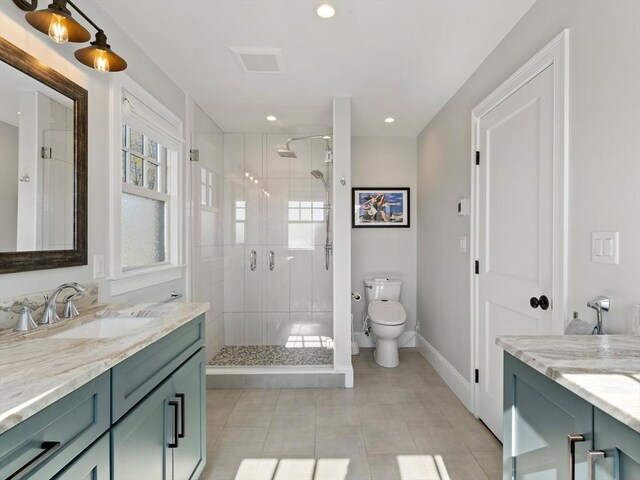 bathroom with vanity, tile patterned flooring, a stall shower, and toilet