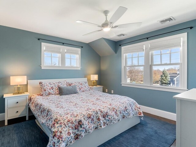 bedroom featuring baseboards, ceiling fan, dark wood-style floors, and visible vents