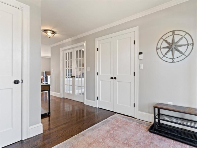 foyer with baseboards, ornamental molding, french doors, and wood finished floors