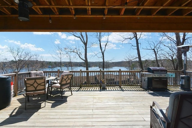 wooden deck featuring outdoor dining area and a water view