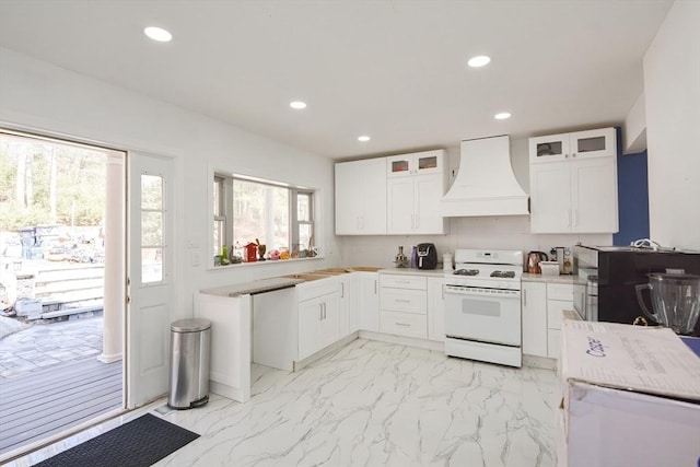 kitchen with marble finish floor, white gas stove, recessed lighting, and premium range hood