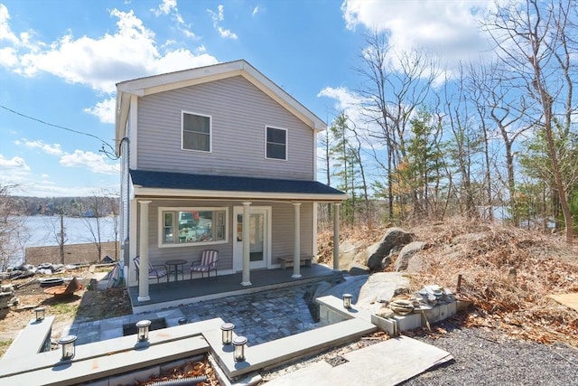 rear view of house with covered porch