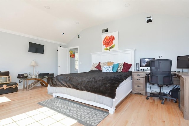 bedroom featuring lofted ceiling and light wood-type flooring