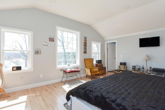 bedroom with baseboards, lofted ceiling, and light wood-type flooring