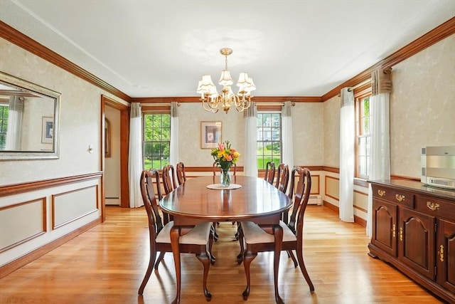 105 Old Barn Path, Marshfield, MA 02050 - dining space featuring healthy amount of natural light, a chandelier, ornamental molding, light wood finished floors, and a decorative wall