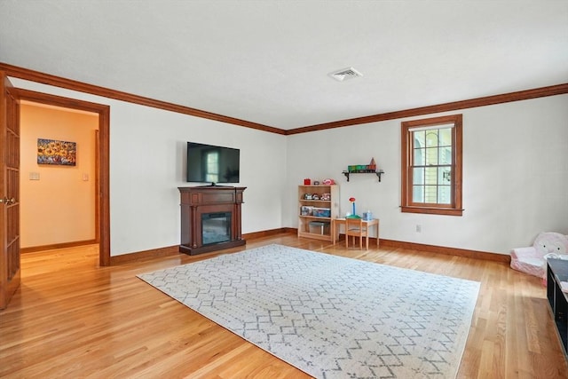 105 Old Barn Path, Marshfield, MA 02050 - living room featuring baseboards, crown molding, light wood-style flooring, and a glass covered fireplace