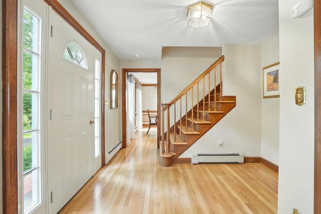 105 Old Barn Path, Marshfield, MA 02050 - foyer featuring a baseboard radiator, stairs, wood finished floors, and baseboards